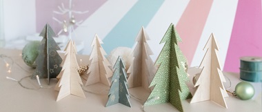 Wooden Christmas tree decorations cut from balsa wood.