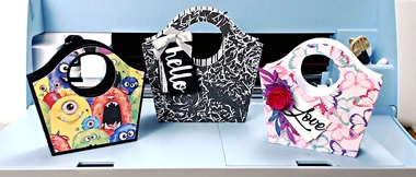 Three paper tote bags on open Brother ScanNCut machine