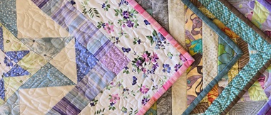 Corners of quilts with bindings stacked on each other