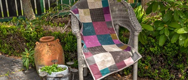 brown burgundy and teal runner quilt made of large and small square wool fabric blocks