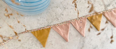 pink and gold velvet bunting on marble background