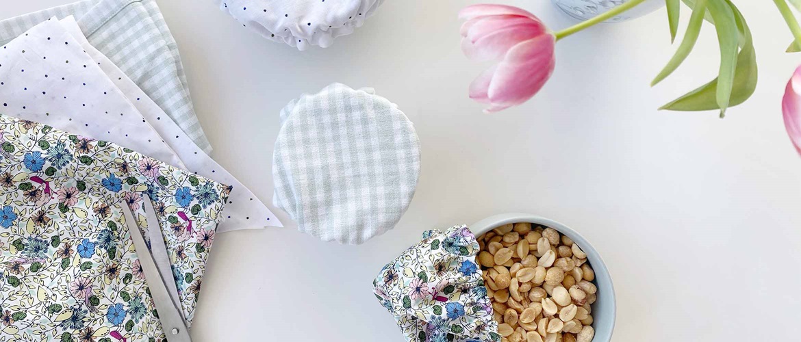 three bowls with floral cotton covers over on white background