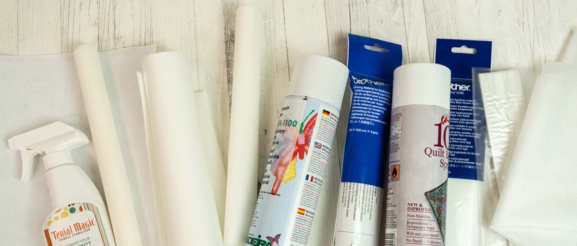 White rolls of stabilizer and cans on wooden background