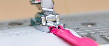 Close up of pink zipper and invisible zipper foot