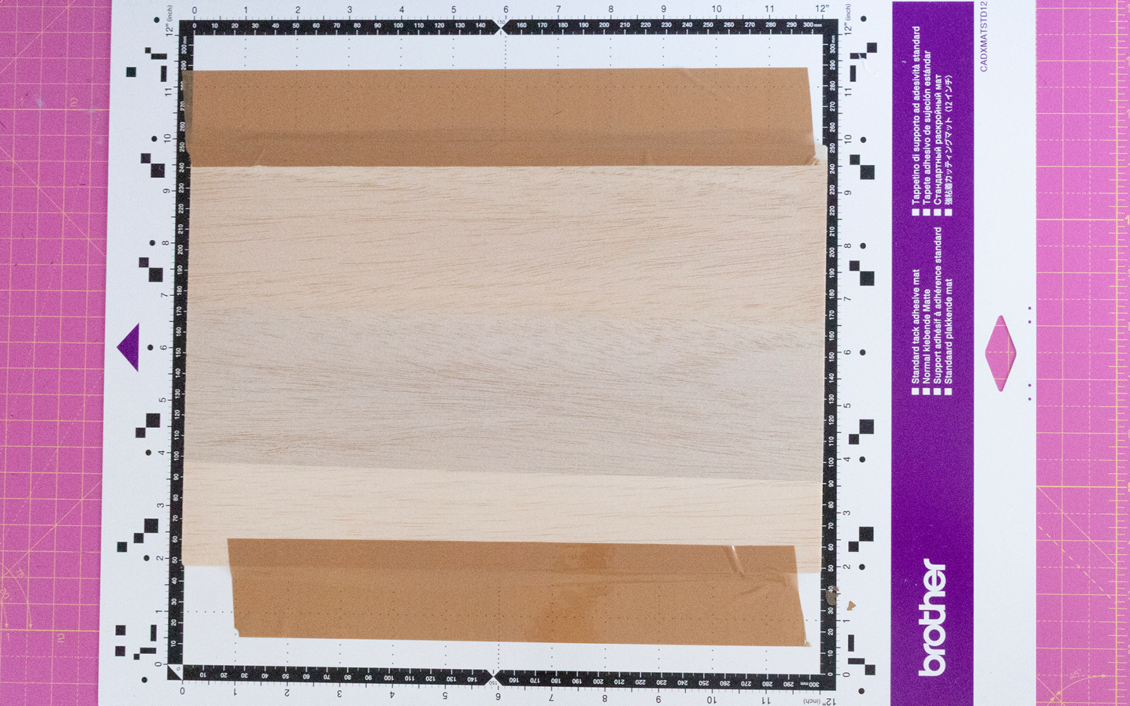 Balsa wood taped securely onto a ScanNCut cutting mat.