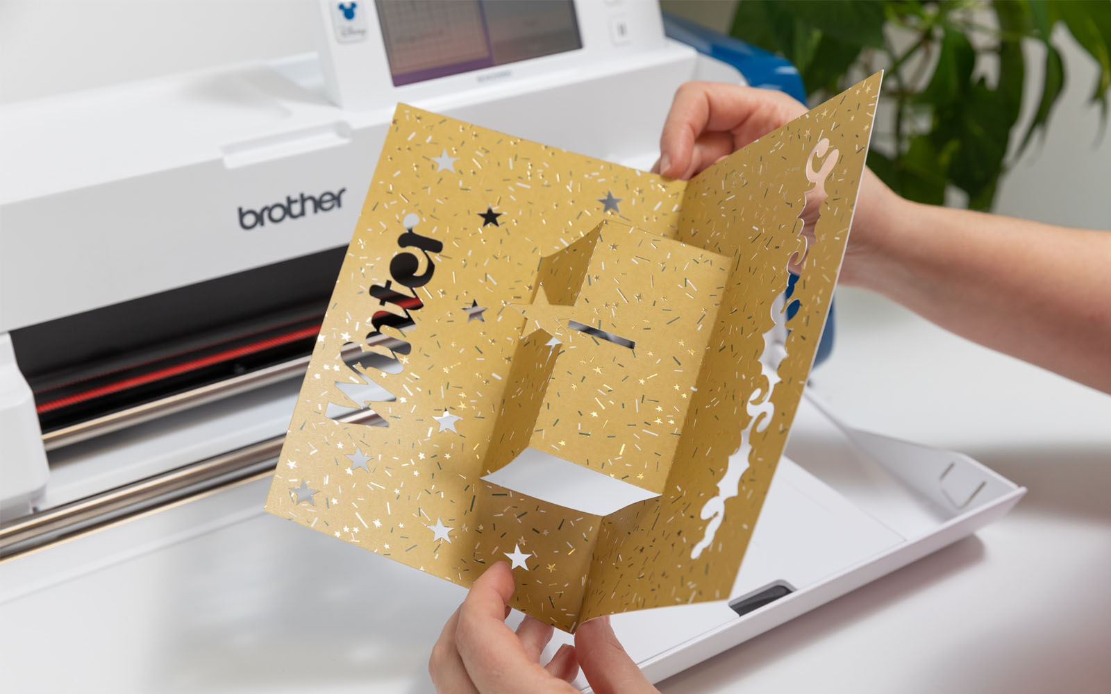 Hands folding hand-made pop-up Christmas card