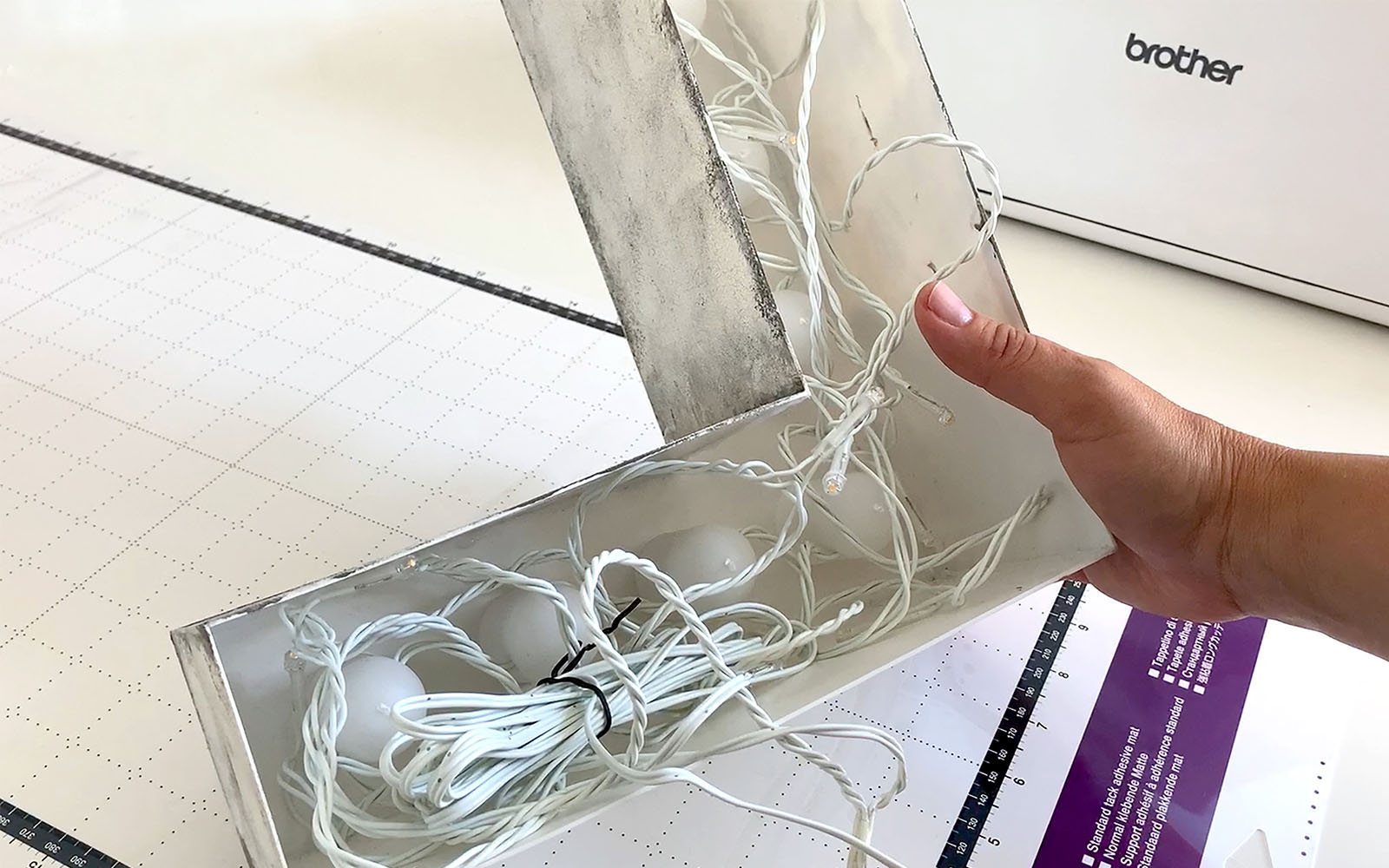 back of L shaped grey light showing wires in light body