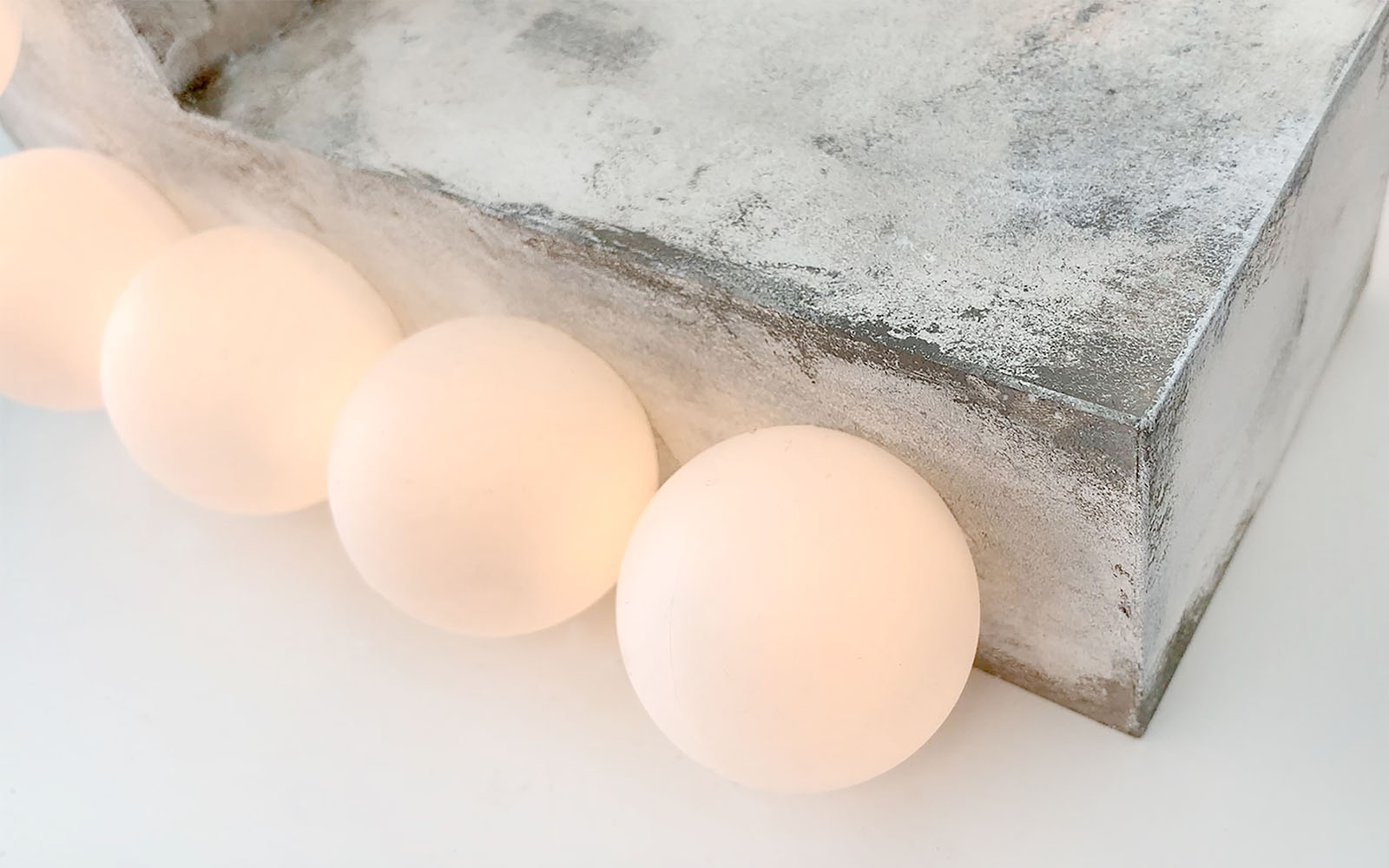 Three warm white bulbs on a 3D grey rectangle