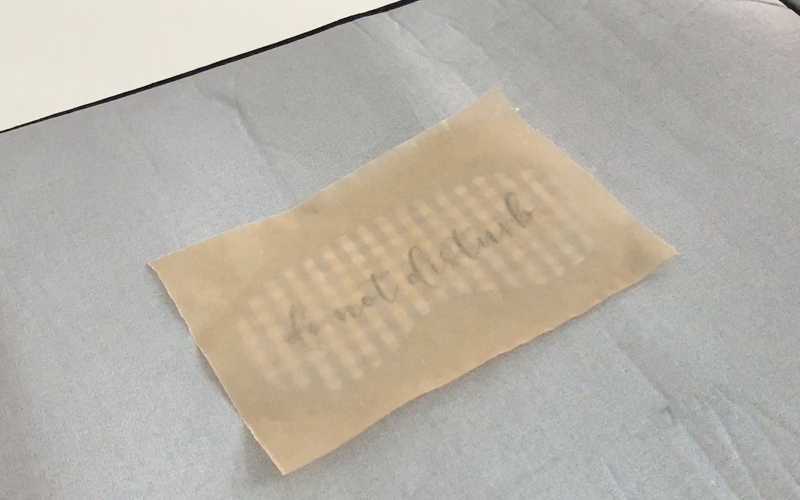 Baking paper placed over sleep mask shaped piece of cotton