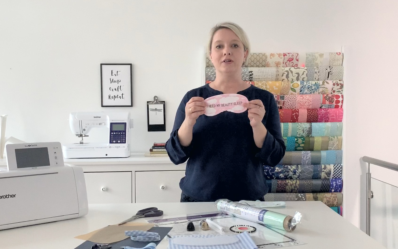 Short haired blond woman in craft studio with pink sleeping mask