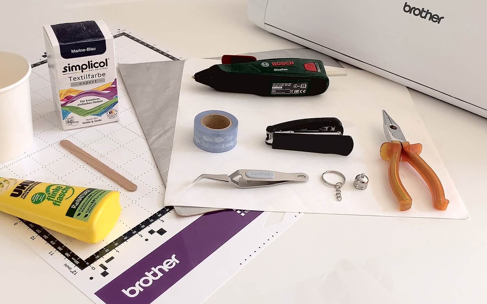 Materials needed to create tassel keyring - glue, pliers, vegan leather