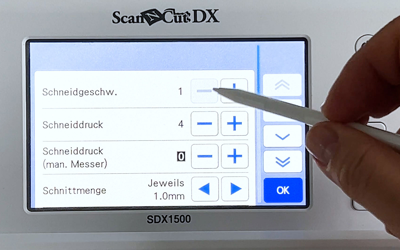 Screen of Brother ScanNCut SDX1500 and hand pointing with stylus