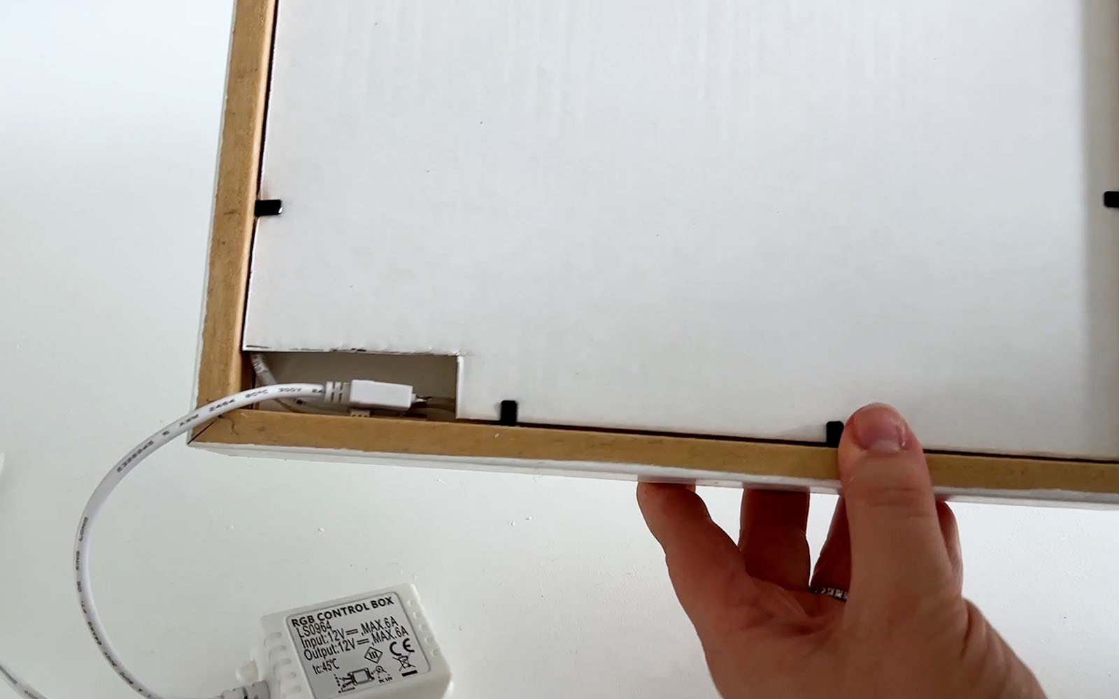 Heavy card with a window for connection point of the LED lights installed at back of lightbox