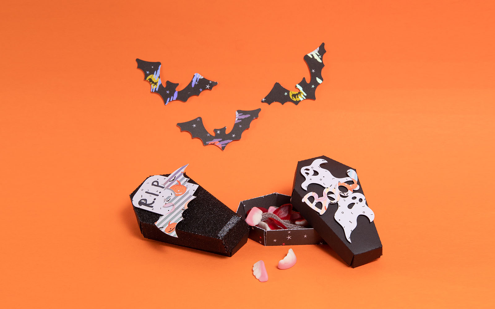black card coffin with 3D ghosts filled with sweets