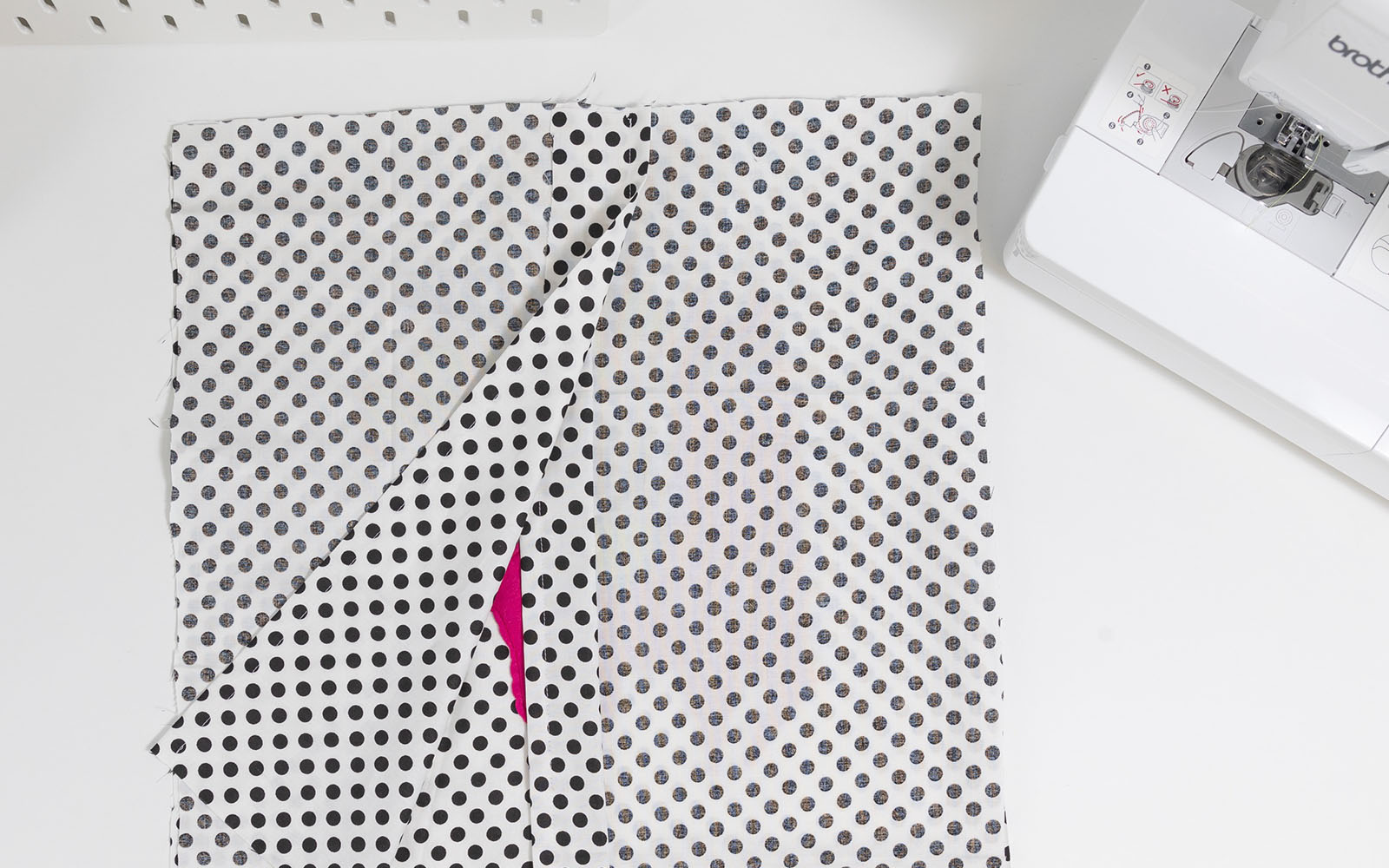 Spotty cushion cover sewing pieces pinned together on desk
