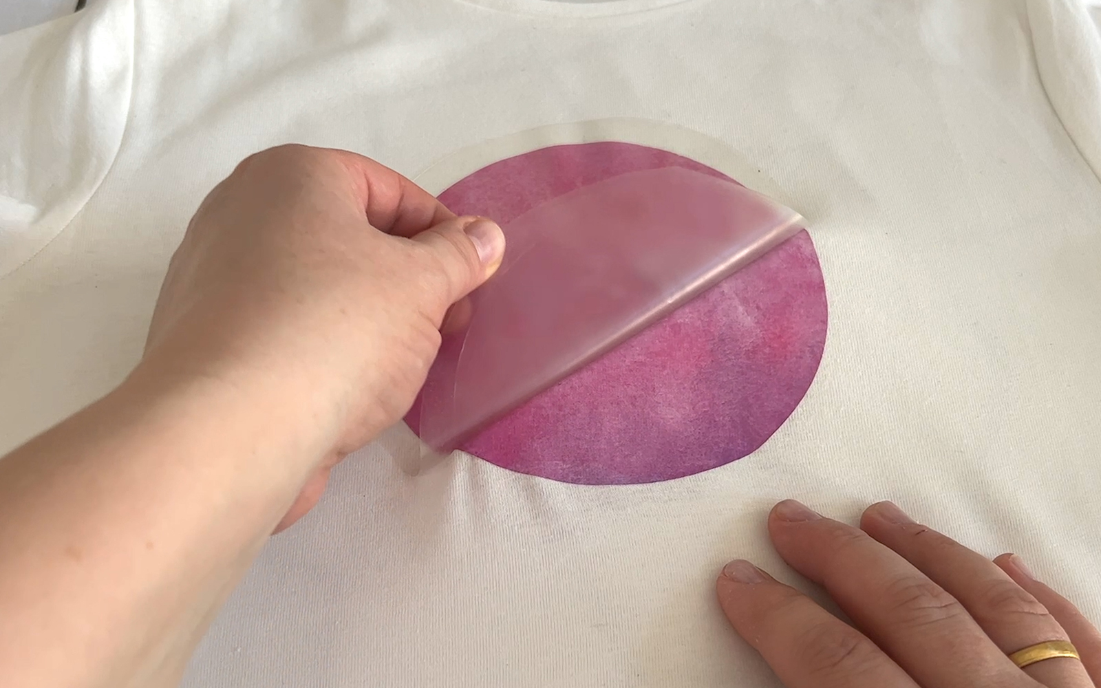 A hand holding a blue cut paper flower