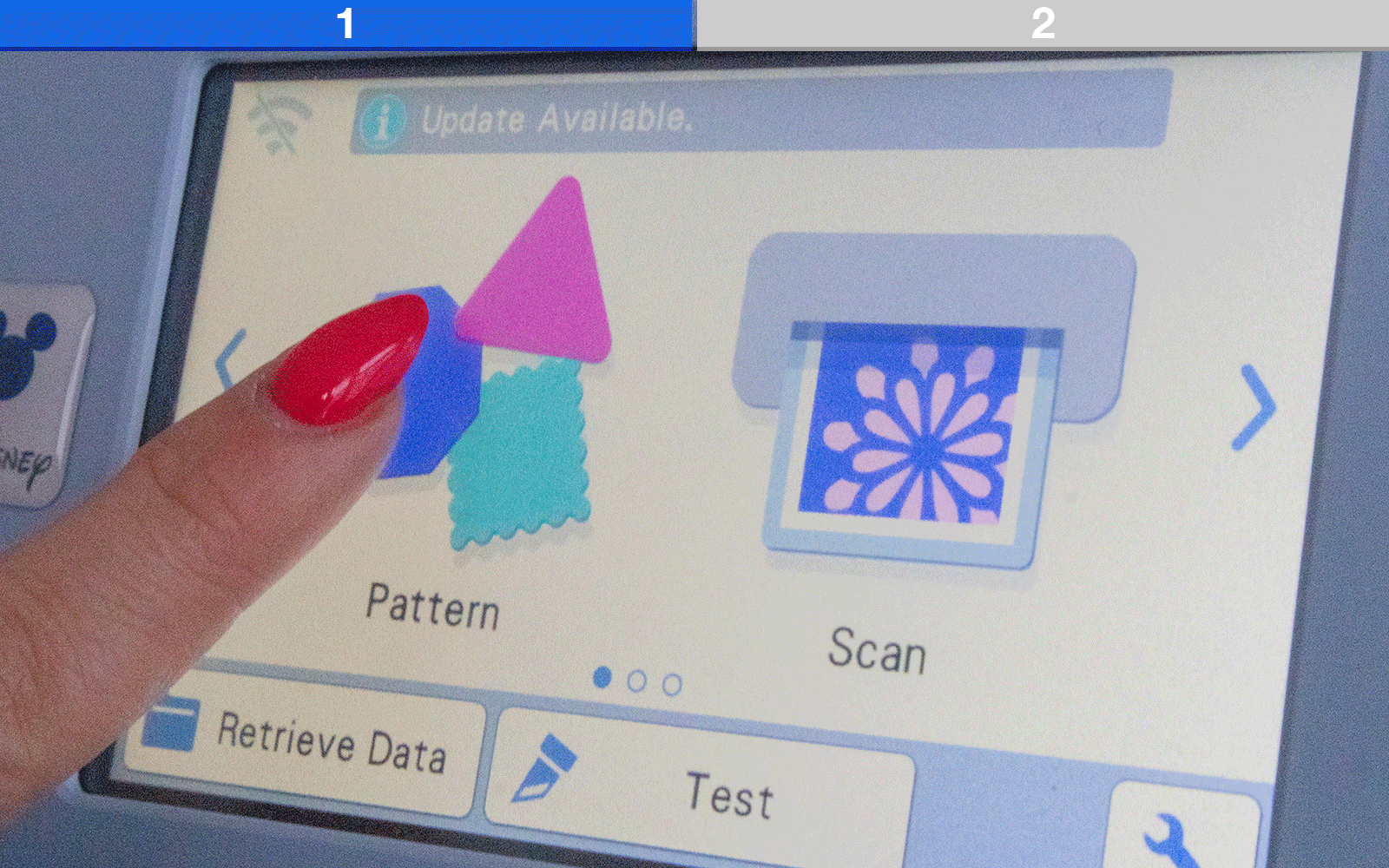 Finger with red nail selecting patterns on ScanNCut touchscreen