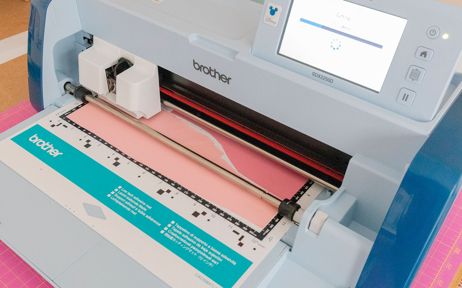 ScanNCut machine with the mat fed into it, with heat transfer vinyl placed on top 