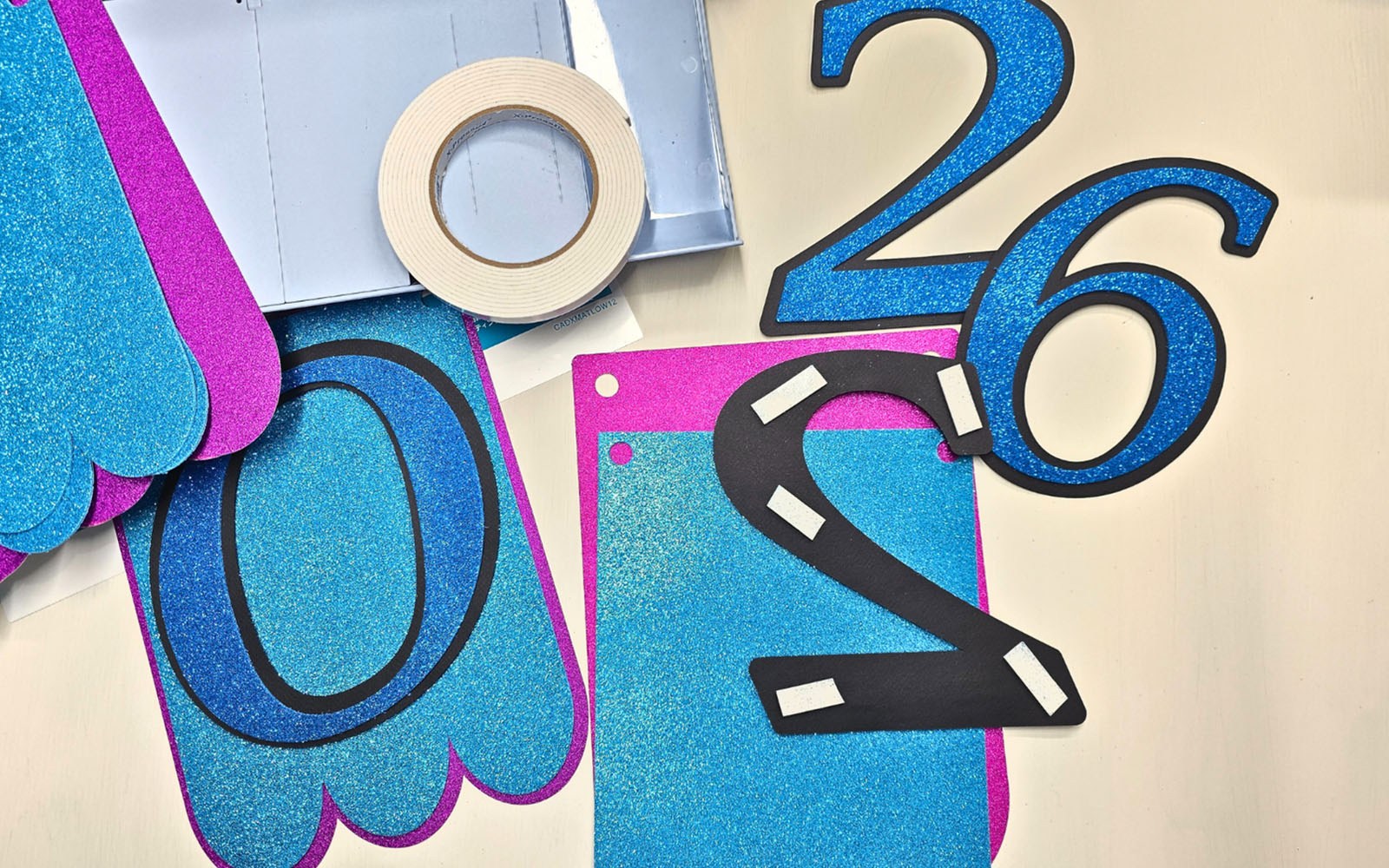 Black 2 with white foam tape on pink and blue bunting