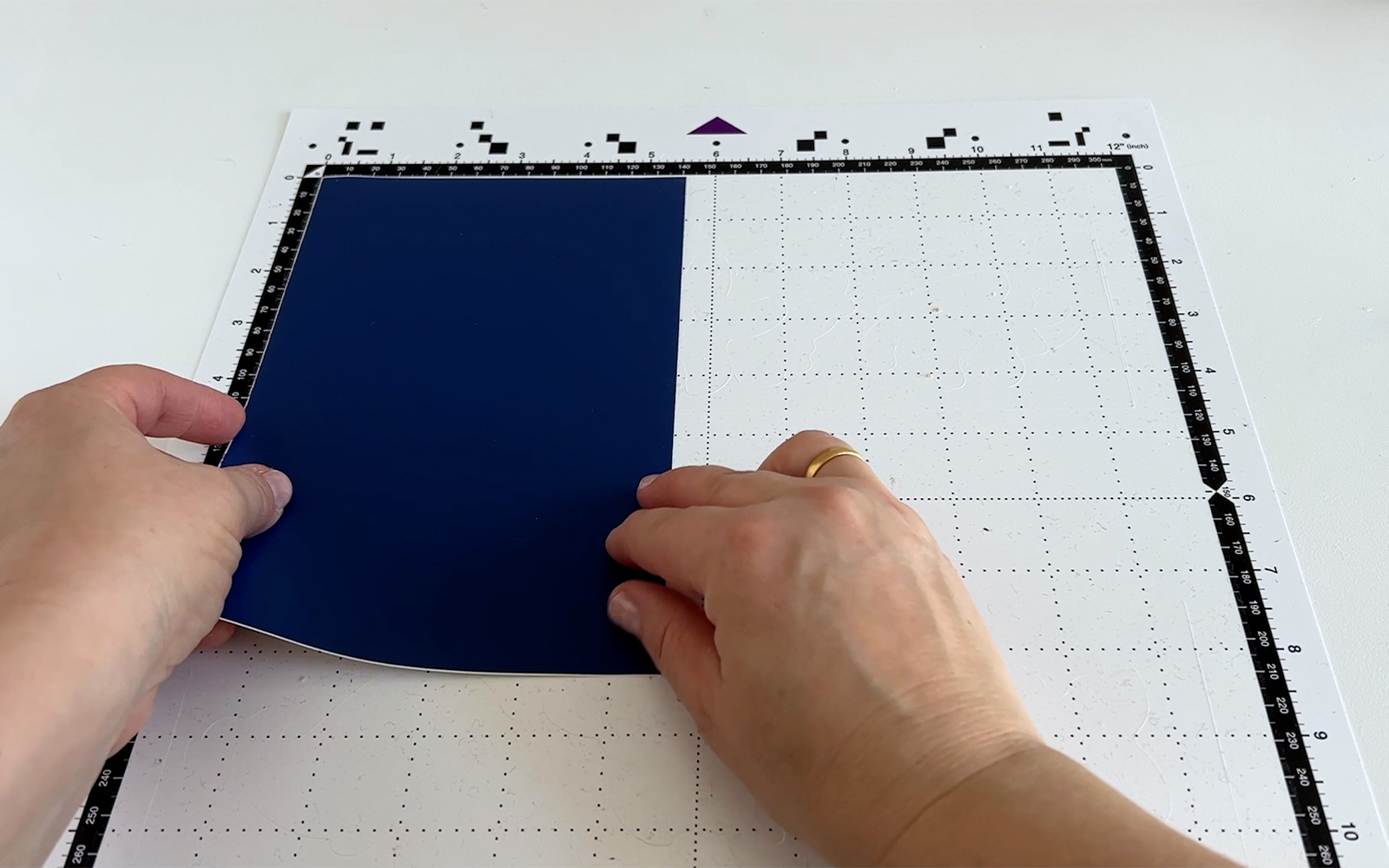 Blue craft vinyl being attached to Brother ScanNCut standard tack mat