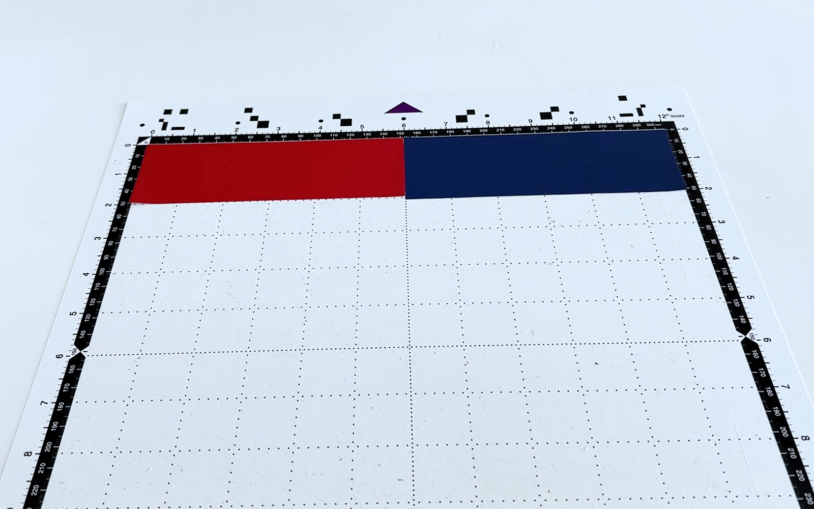 Red and blue vinyl rectangles attached to Brother ScanNCut standard tack cutting mat