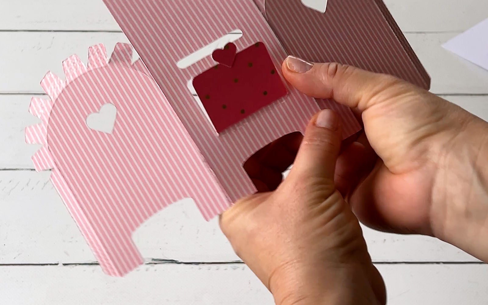 Hands pressing on card