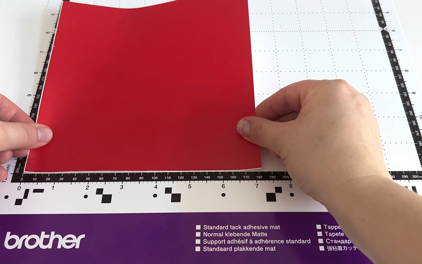 Red craft vinyl is placed on Brother Standard tack mat
