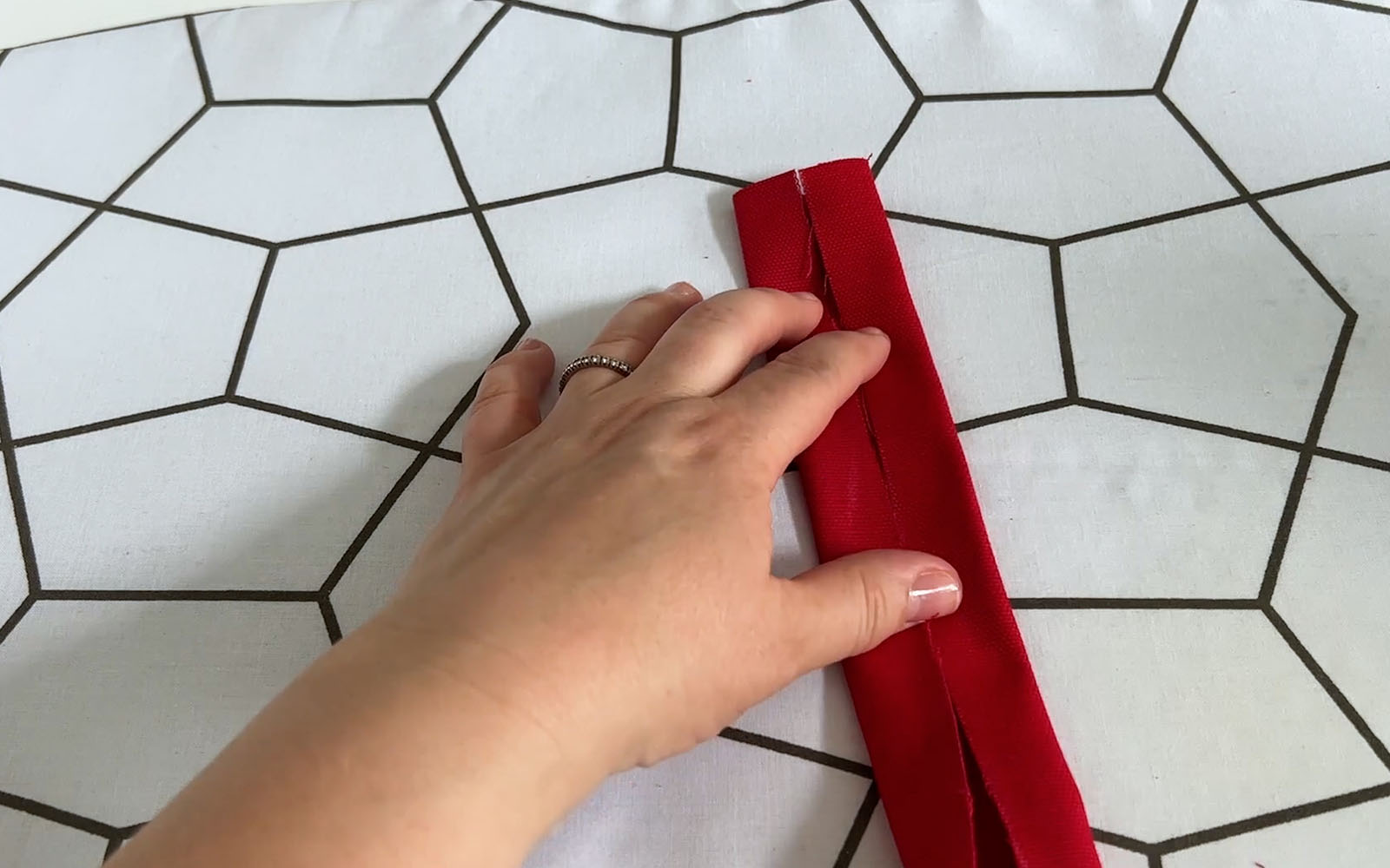 Folded red fabric ironed in half and folded in