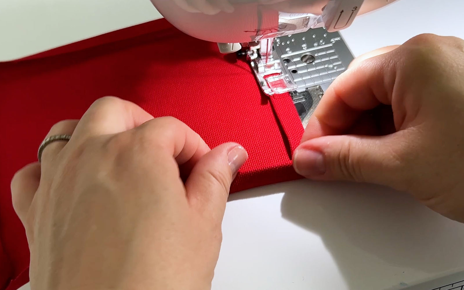 Sewing folded red fabric