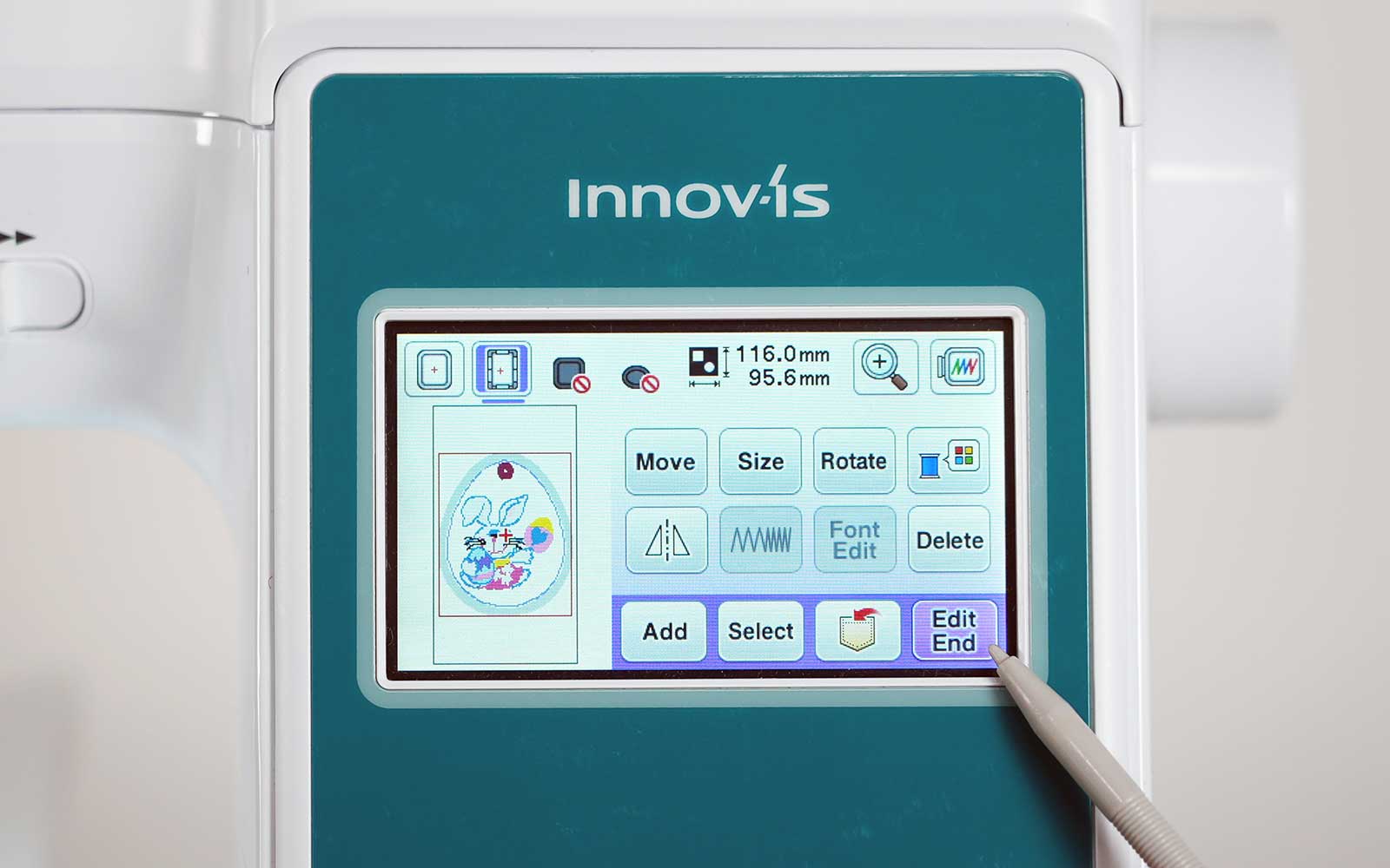 Stylus pointing at ‘end edit’ button on Brother embroidery machine