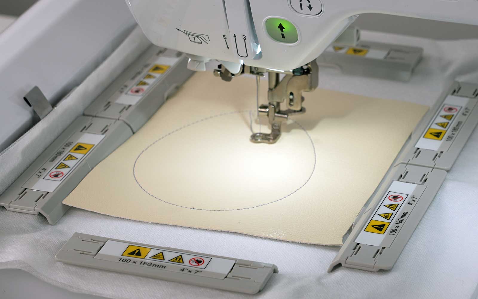 Magnetic embroidery frame with light yellow vinyl in Brother machine