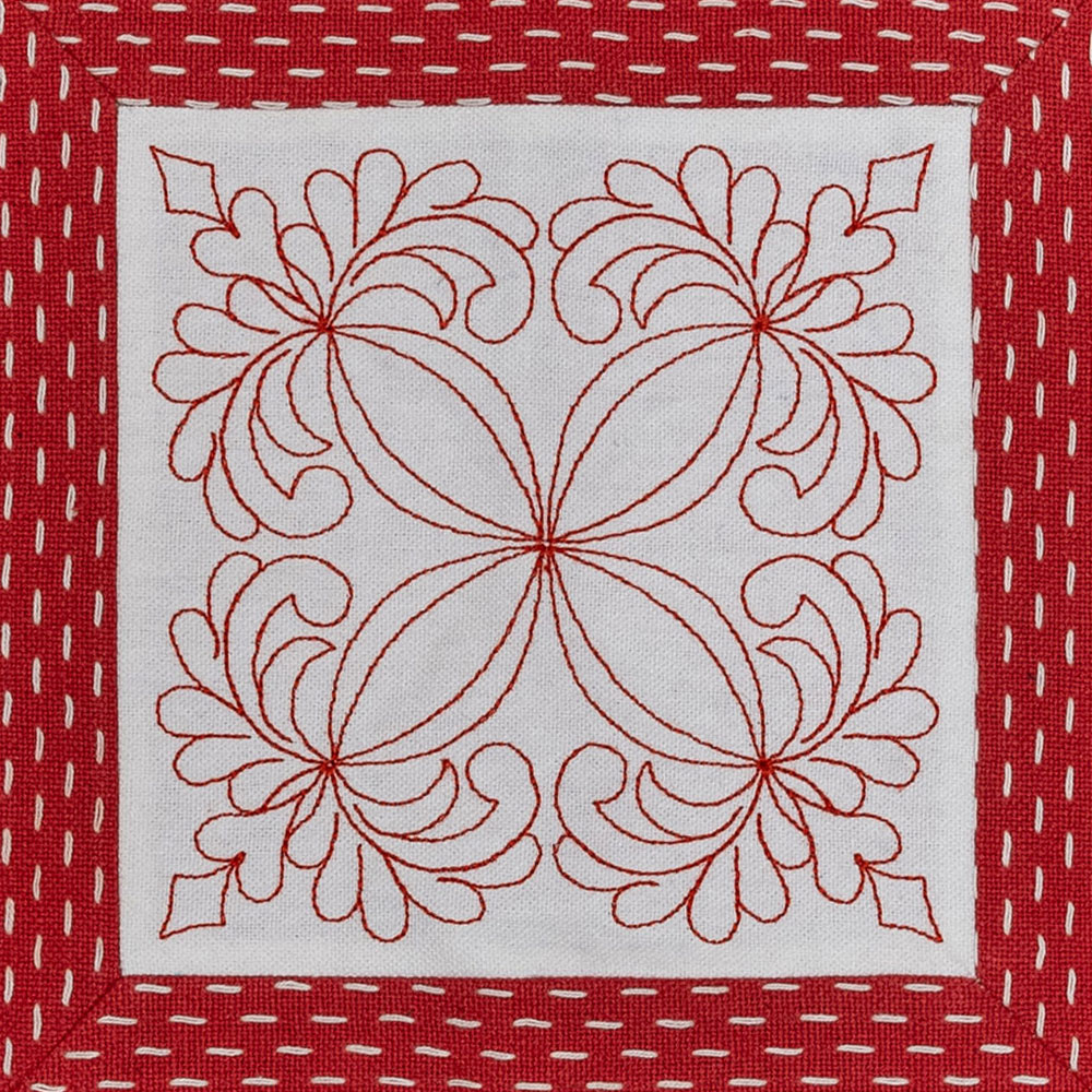 white fabric with red embroidery on sashiko border