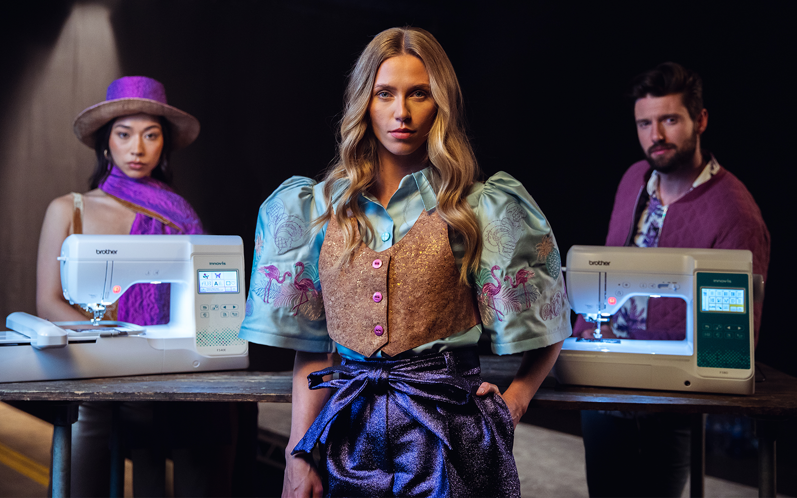 A lady showcasing two Brother entry-level machines with user-friendly features.