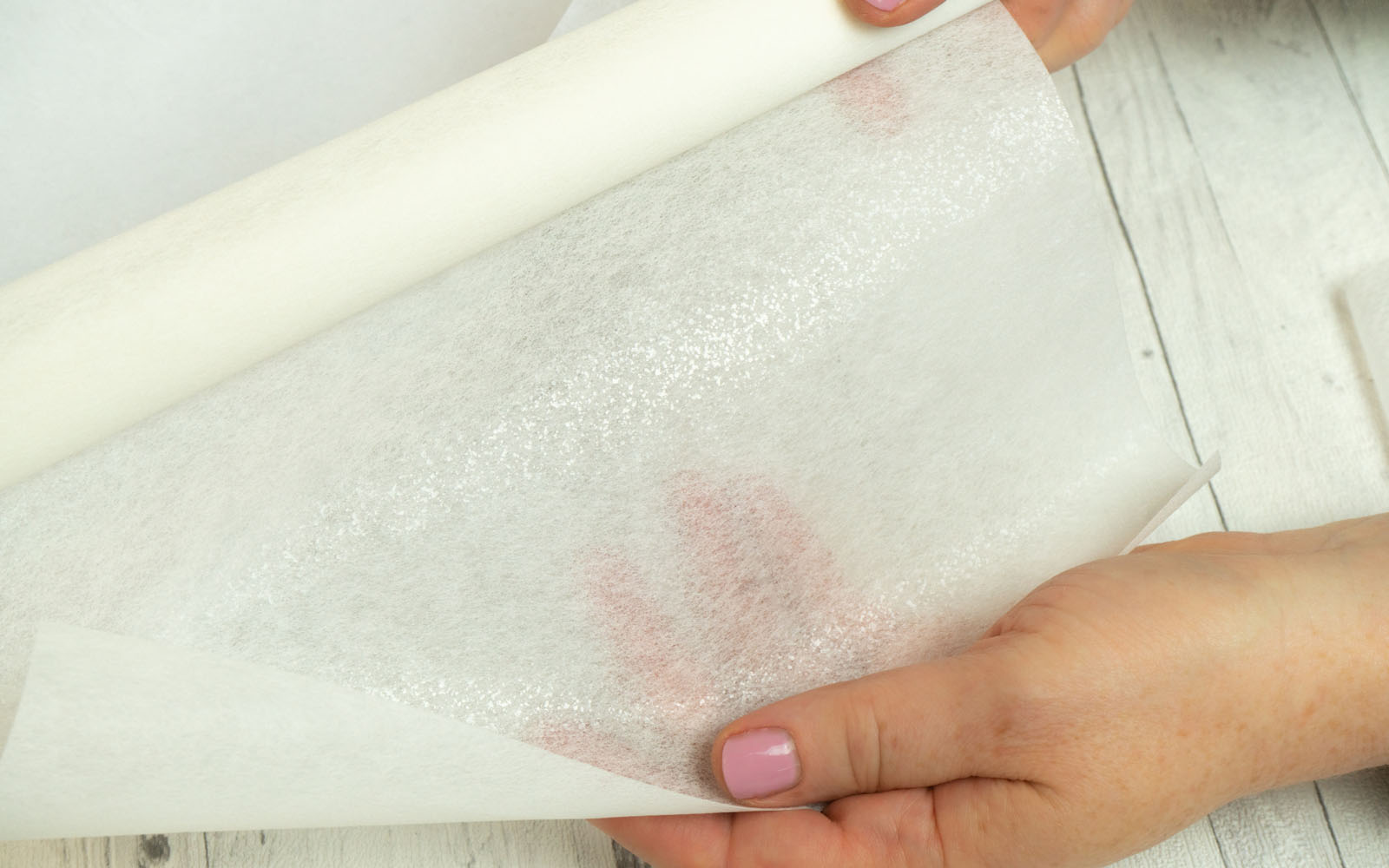 White stabilizer and woman’s hand on wooden background