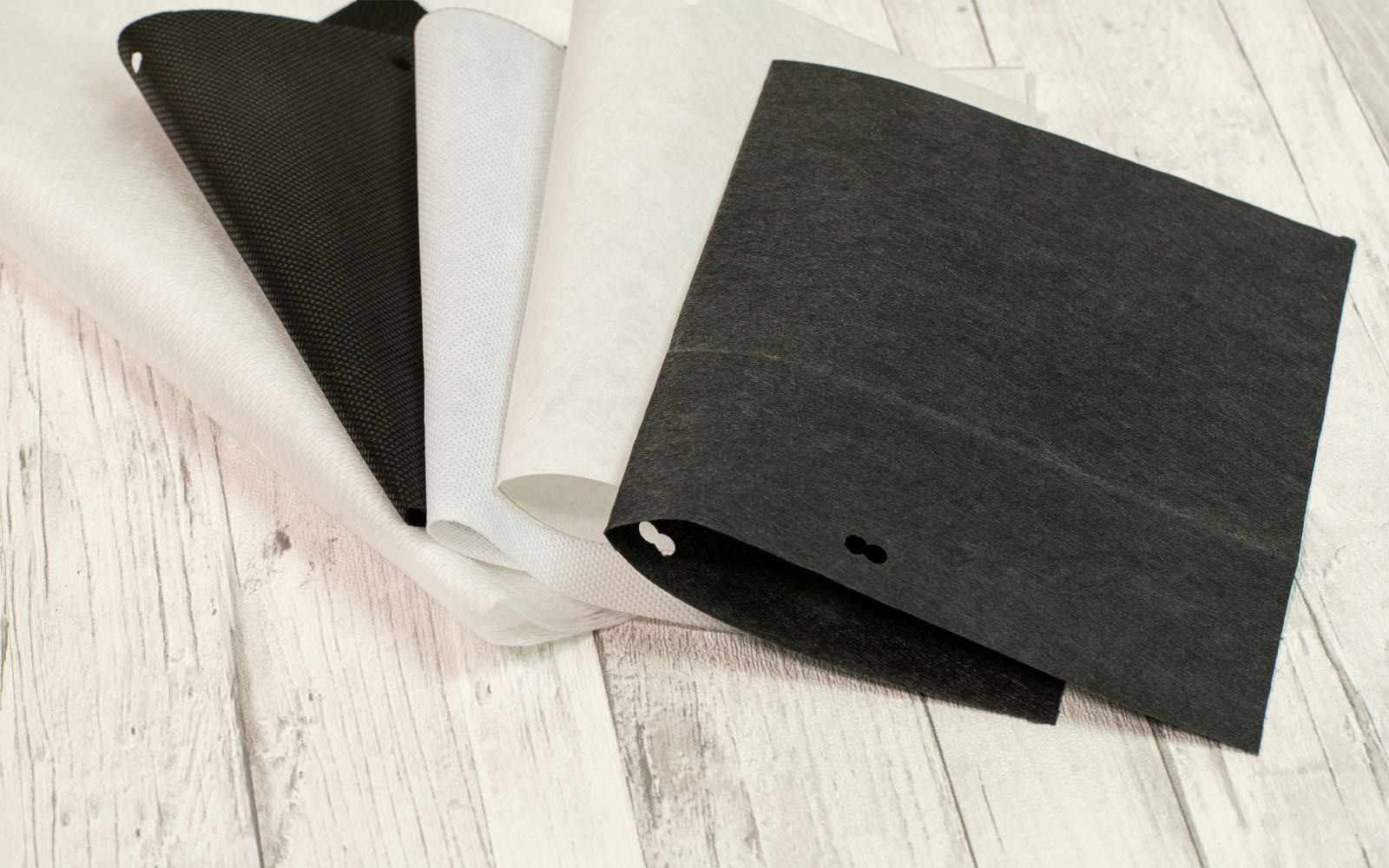 White and black fabric on wooden background