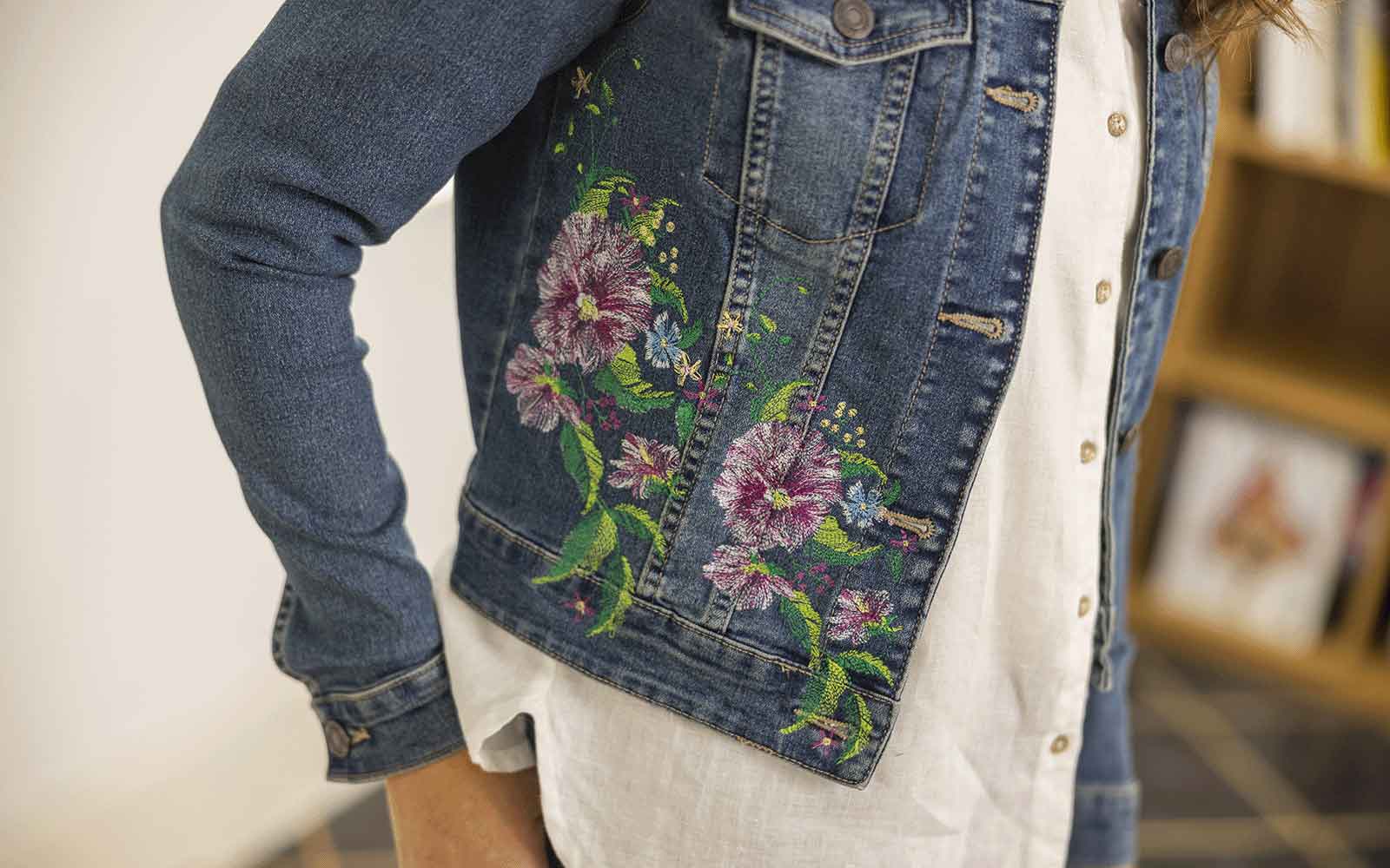 Flower and leaf embroidery pattern on a denim jacket, featuring a perfect example design for machine embroidery.