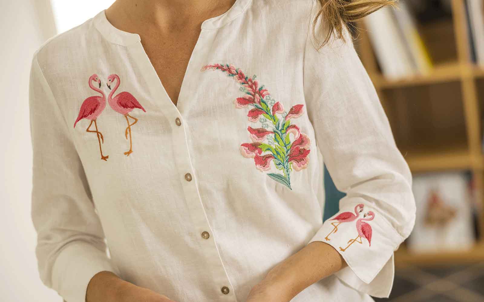 Flamingo and flower bouquet embroidery on a lightweight linen shirt, a fresh and vibrant design.