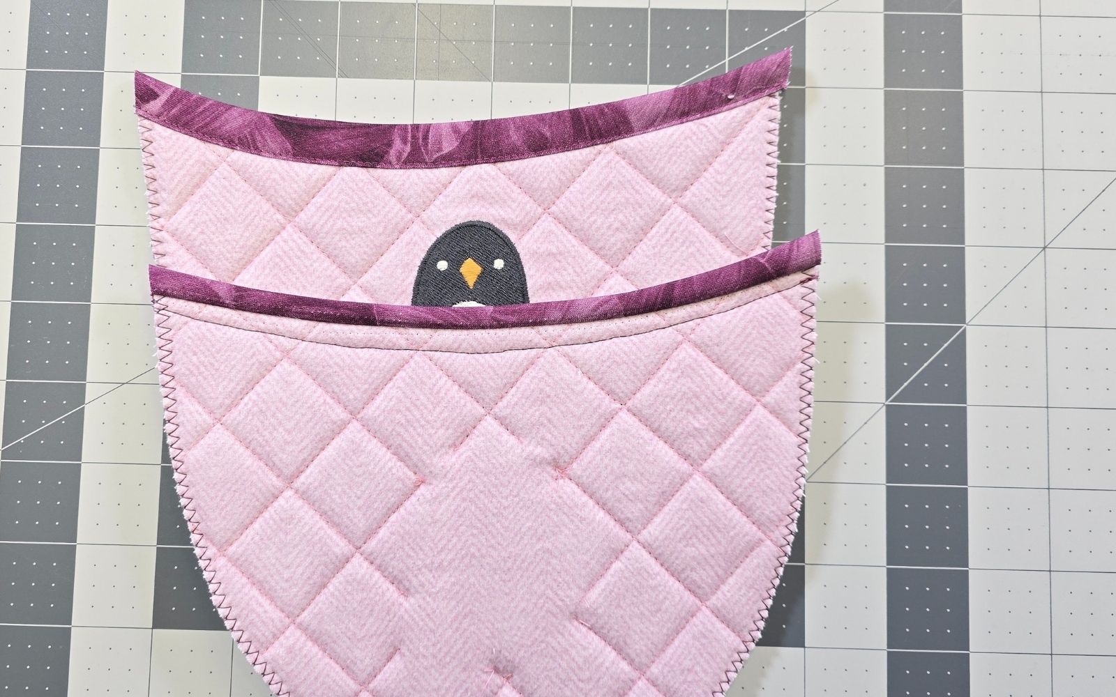 Pink quilted slipper tops on grey cutting mat