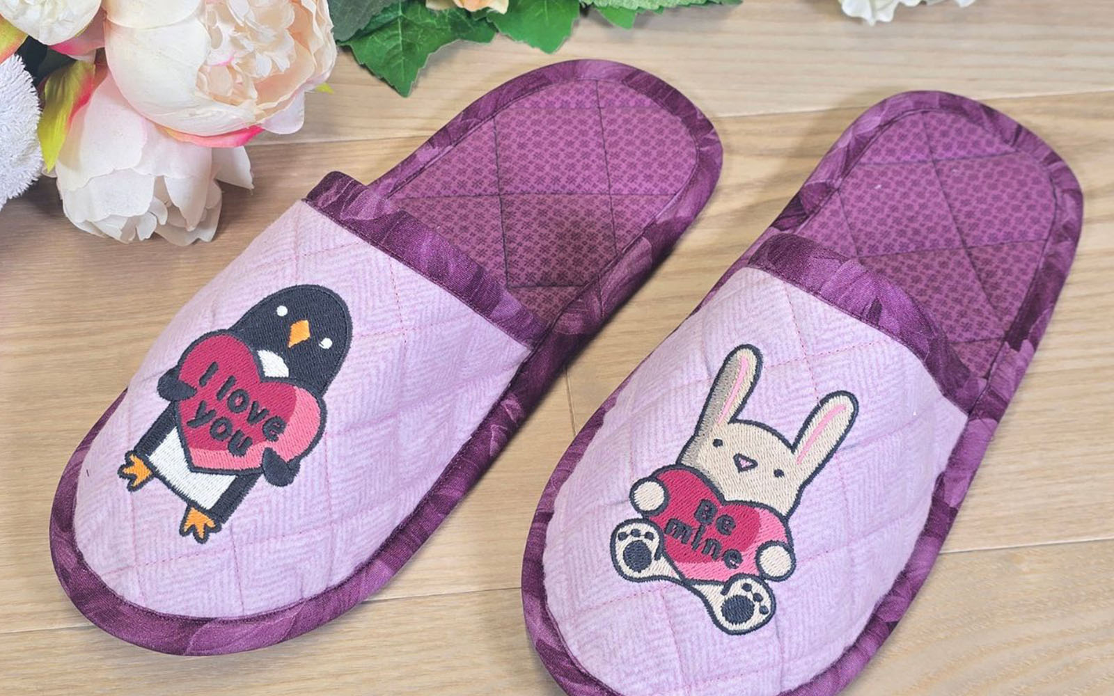 Topstitch detail on pink embroidered slippers