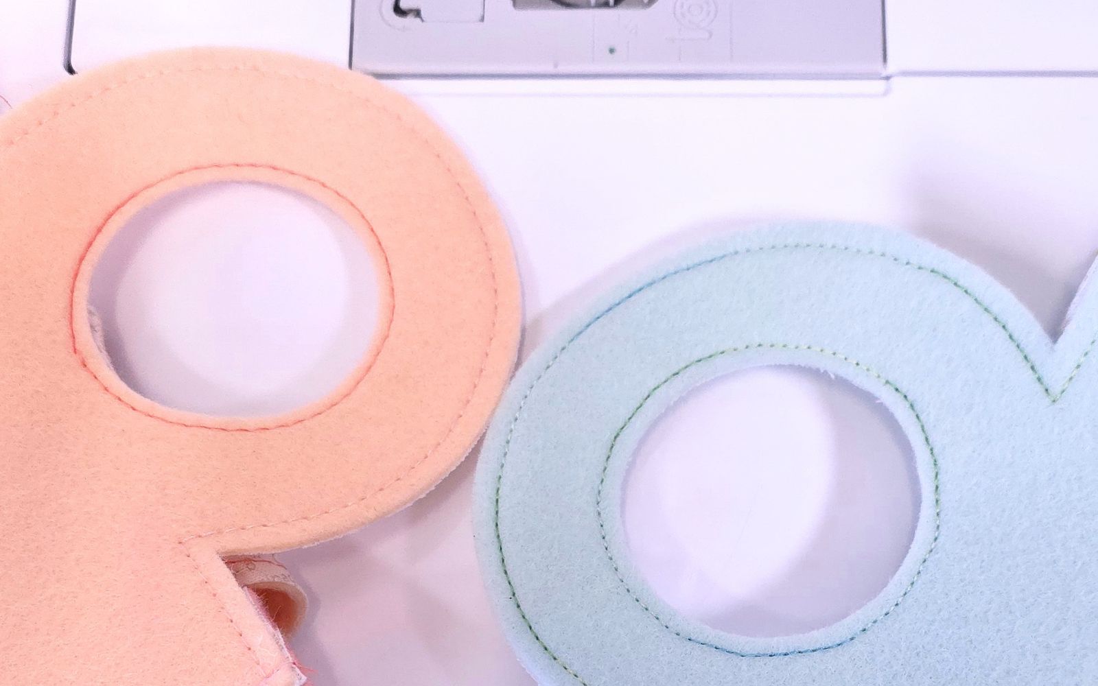 Blue and peach felt gift bag handles with top stitching