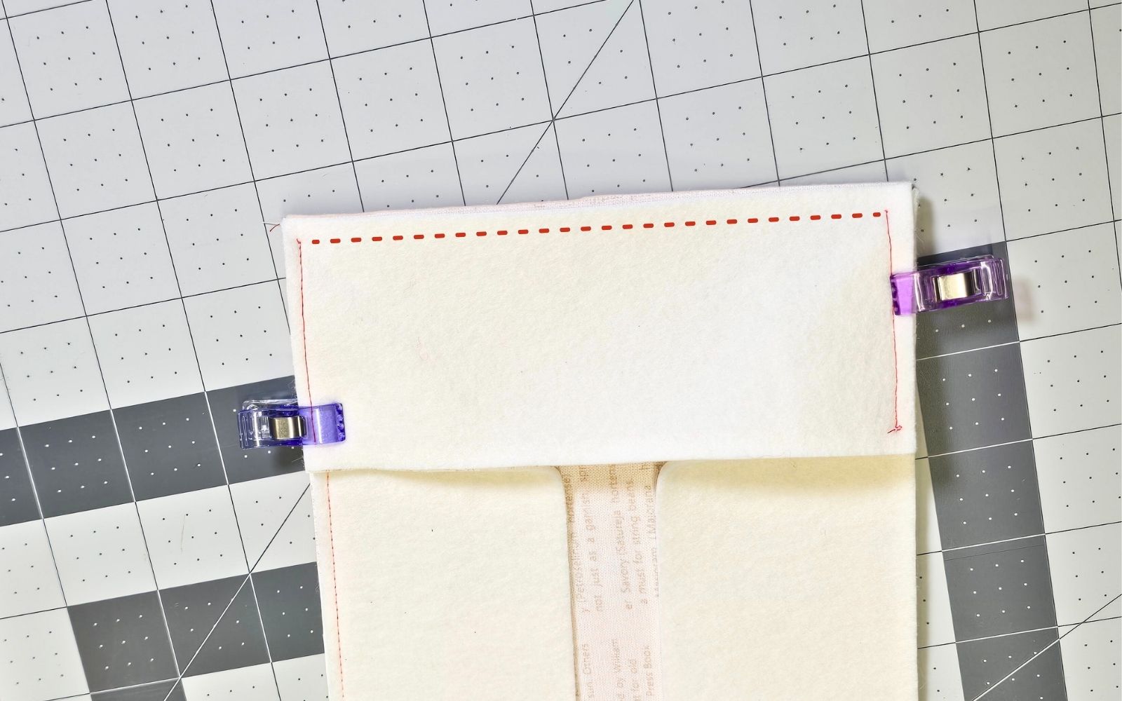 Rectangle cream felt bag gusset piece held with clips