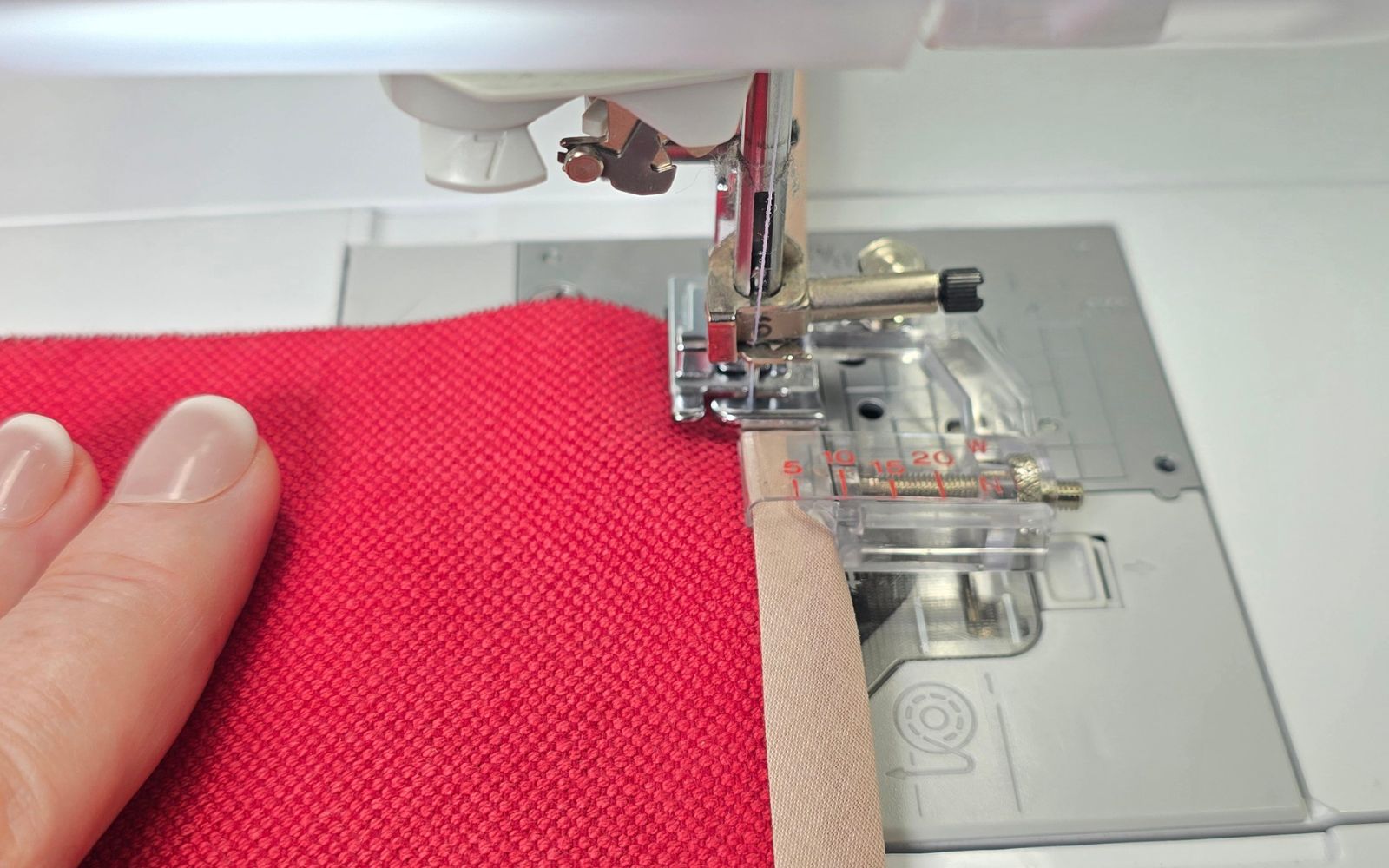 Red fabric and beige binding on Brother sewing machine