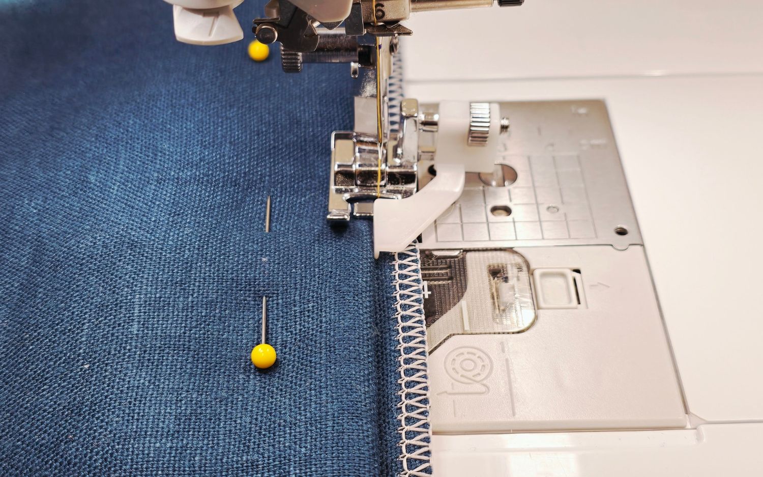 Brother blind hem foot sewing hem on blue fabric