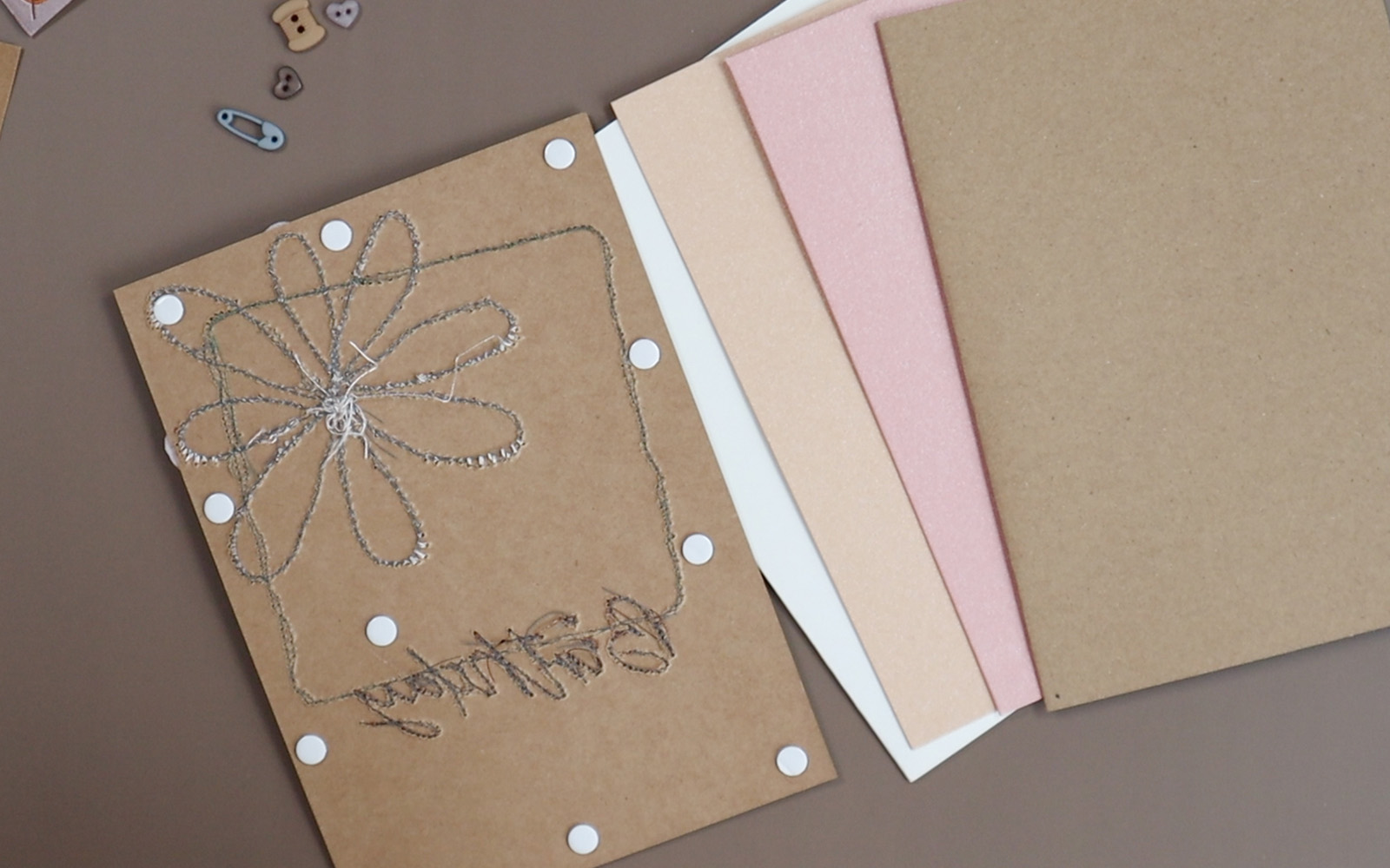 Embroidered card with glue dots to stick onto folded card