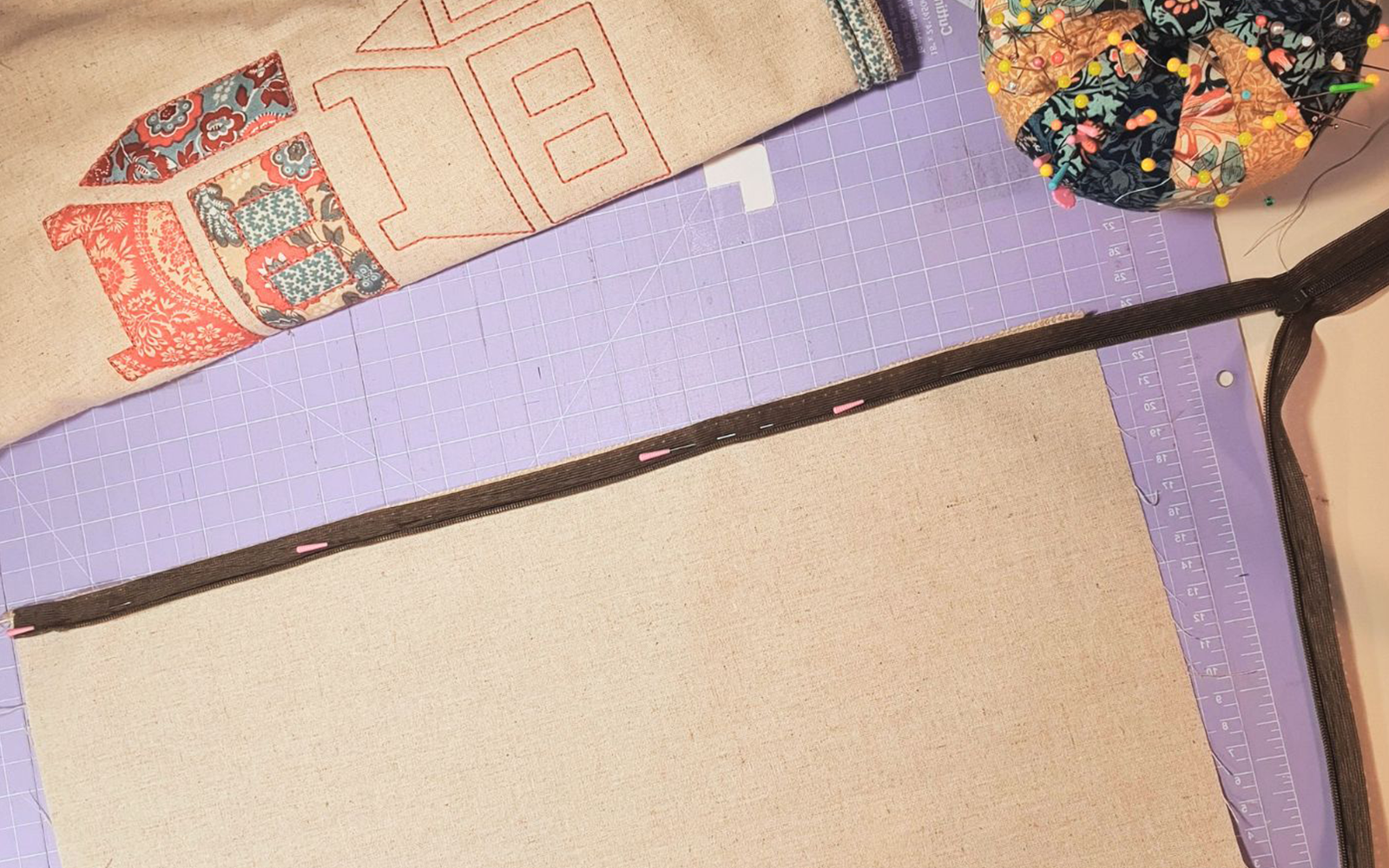 brown zip pinned to linen cushion cover before sewing