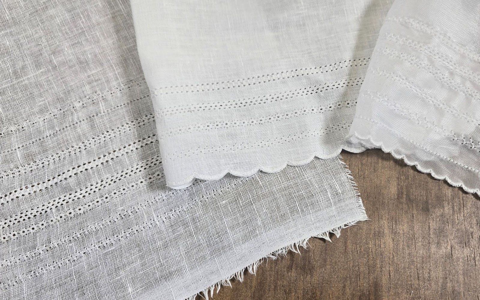 White fabric with variety of heirloom sewing stitches