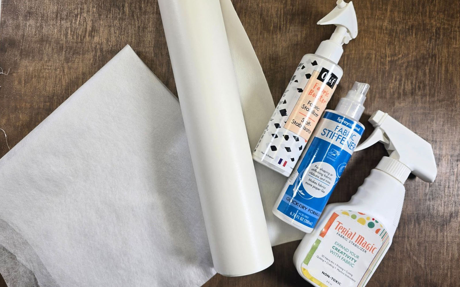 stabilisers and stiffening sprays on wooden background