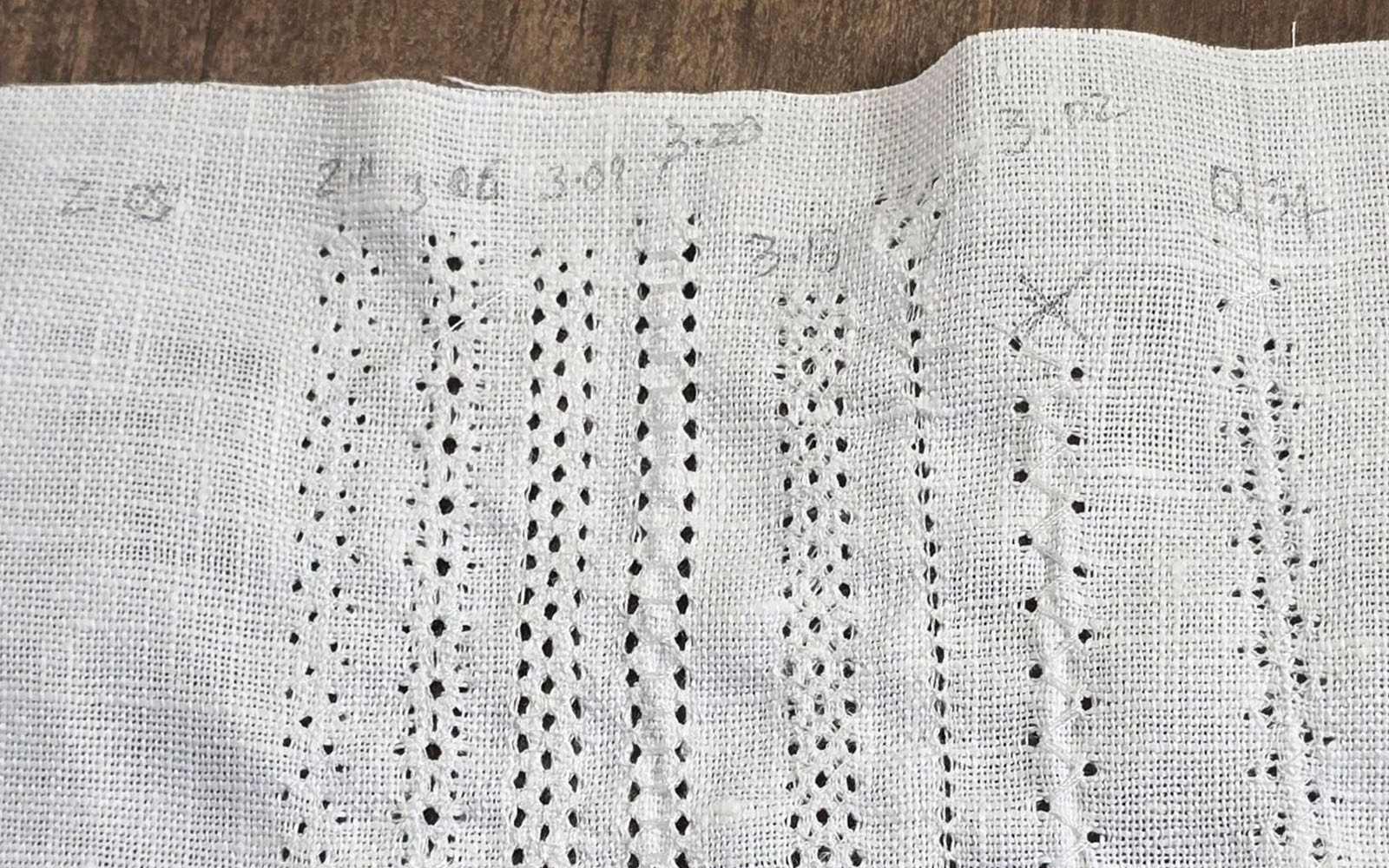 heirloom stitching sampler on white fabric