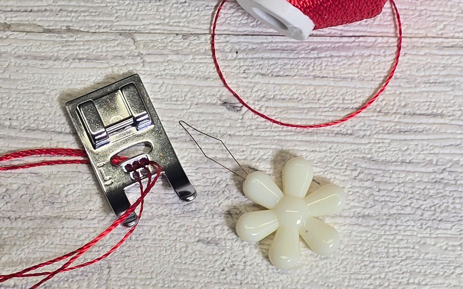 Brother five hole cording foot threaded with red thread