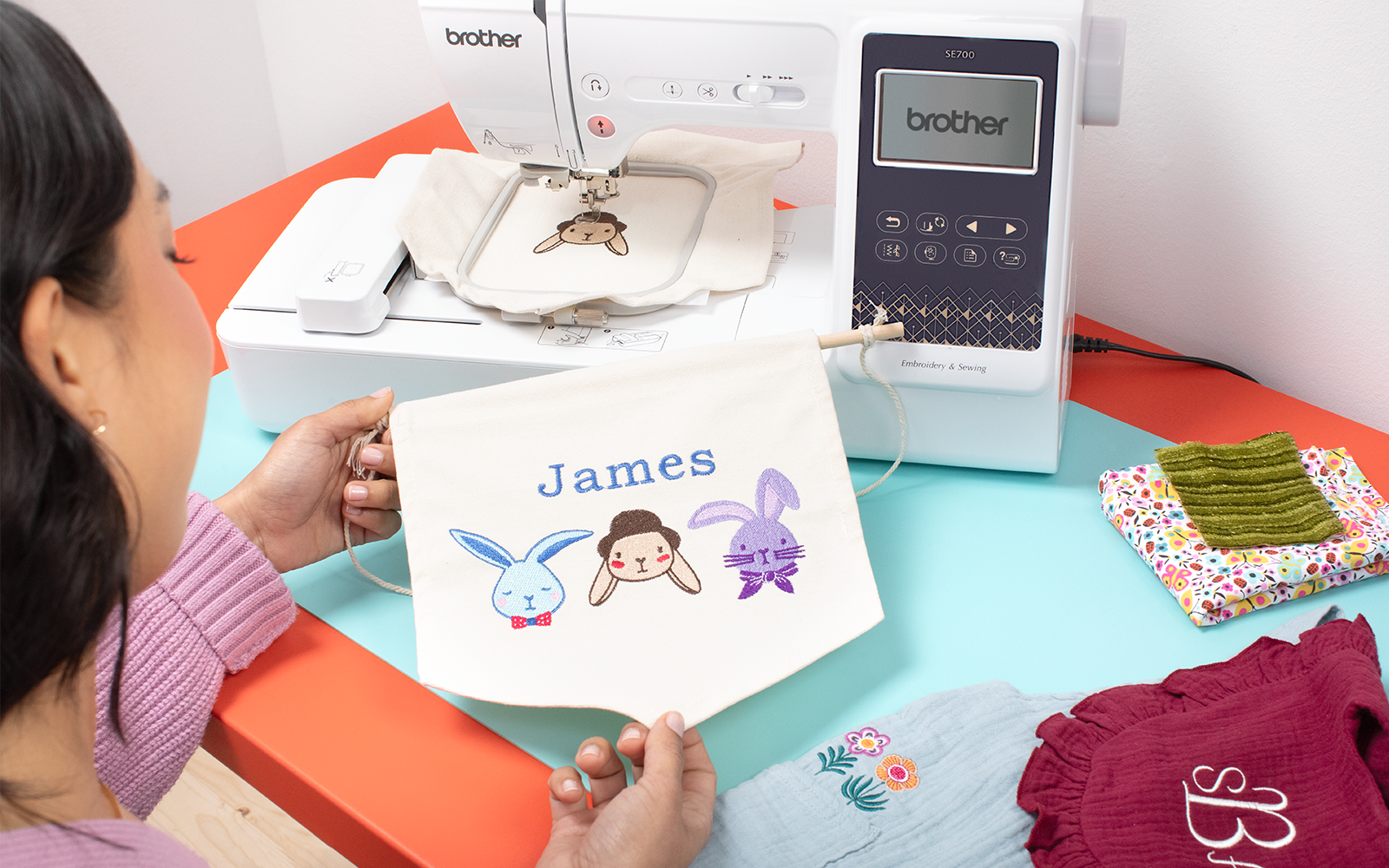 woman holding James embroidery by Brother machine
